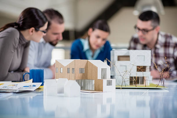 Team of young architects working on a home project in the studio.